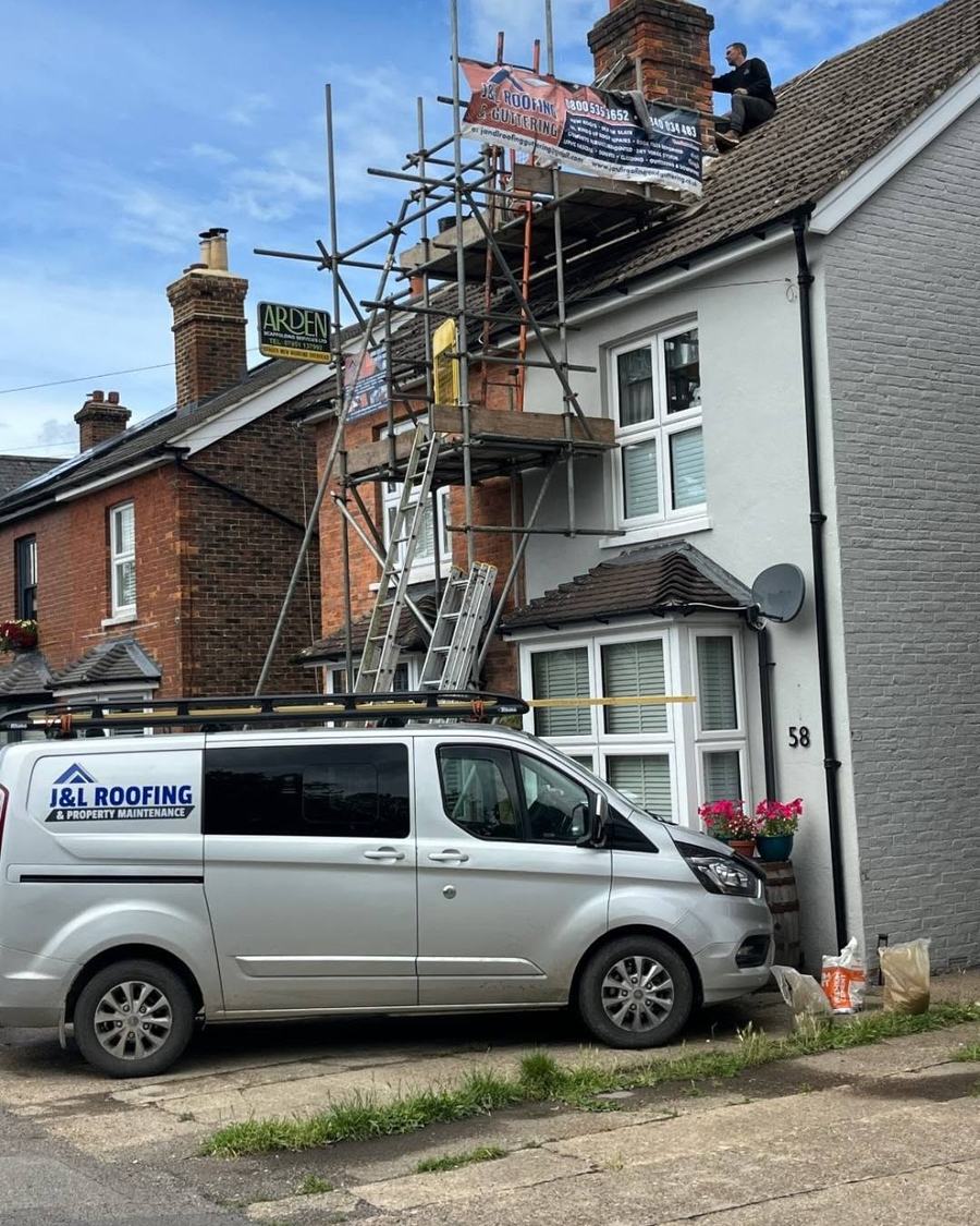 The J&L Roofing and Property Maintenance van outside a re-roof in Surrey