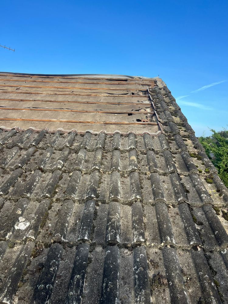 Worn concrete roof tiles before replacement