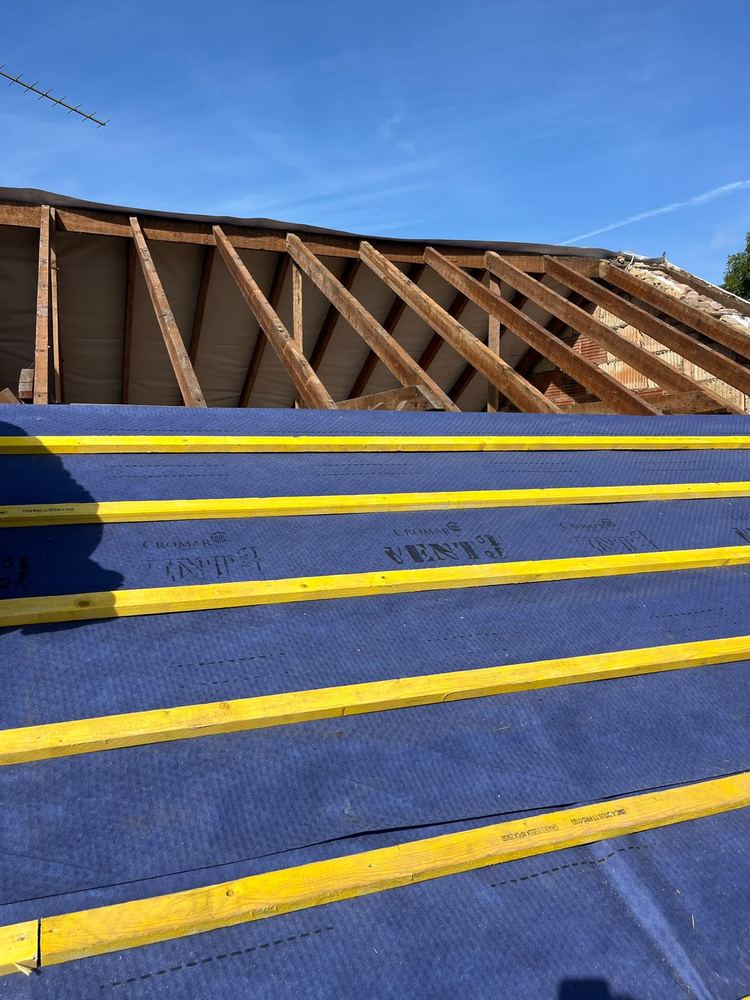 New breather membrane and treated battens laid across a roof