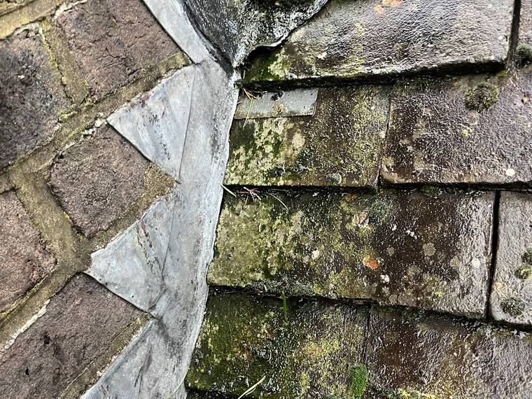 Stepped lead flashing dressed into a tiled roof