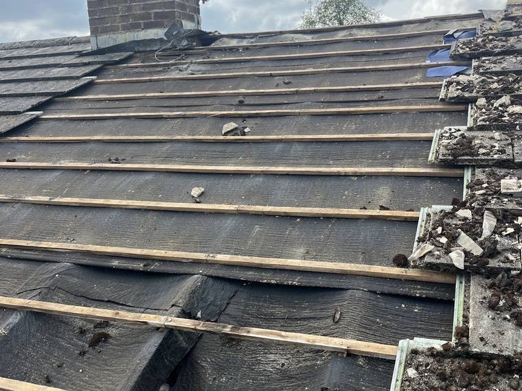 Roof stripped back to the battens for repair